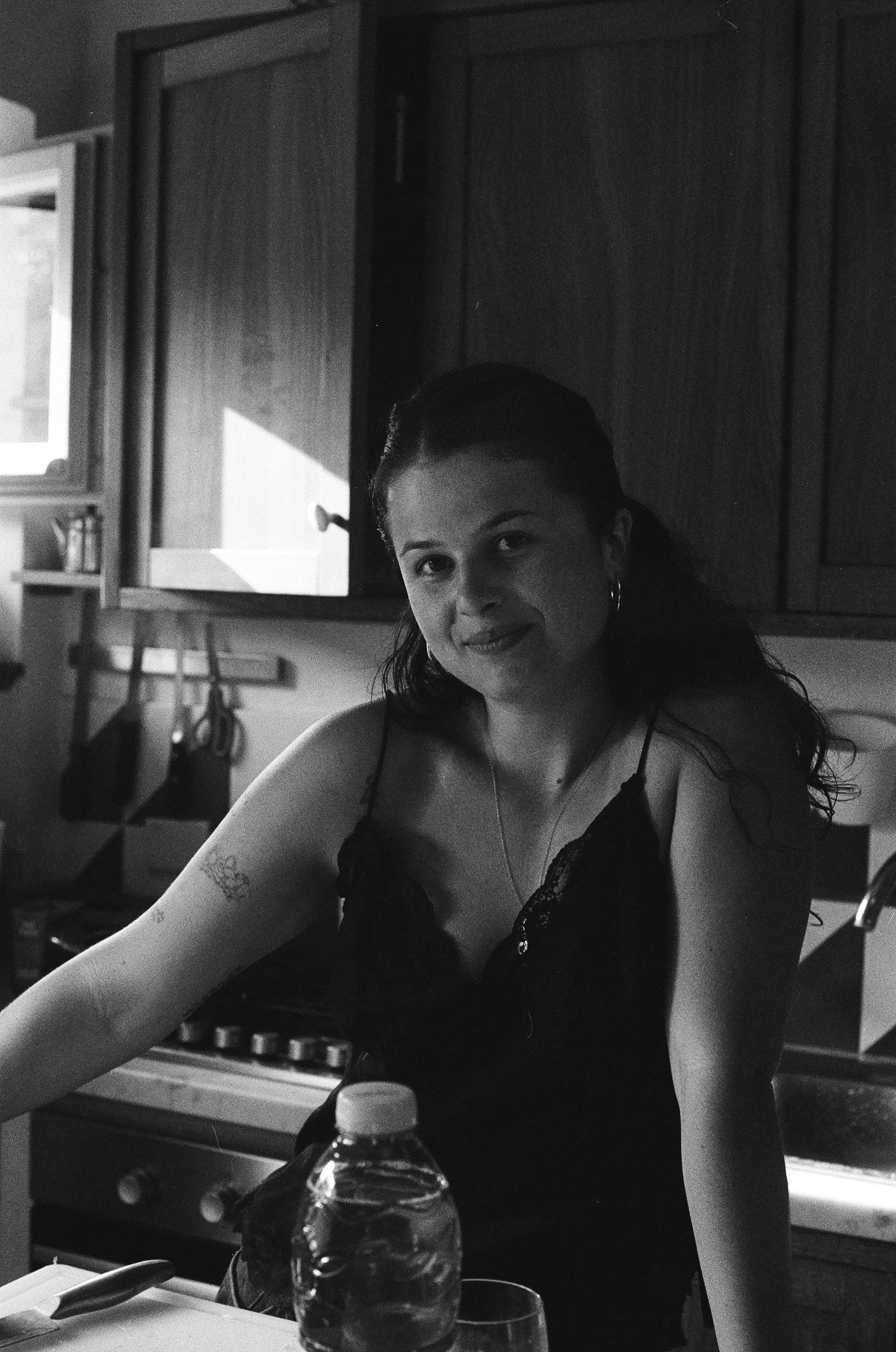A black-and-white portrait in a home kitchen
